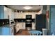 Modern kitchen with white cabinets, stainless steel appliances, and granite countertops at 7152 Sandy Ln, Wesley Chapel, FL 33544