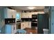 Modern kitchen with white cabinets, stainless steel appliances, and granite countertops at 7152 Sandy Ln, Wesley Chapel, FL 33544