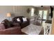 Comfortable living room features hardwood floors, ample seating, and lots of natural light at 7152 Sandy Ln, Wesley Chapel, FL 33544