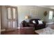 Inviting living room featuring leather furniture and decoratively repurposed paneled door at 7152 Sandy Ln, Wesley Chapel, FL 33544