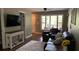 Living room view displaying a comfortable seating area, TV, and view to the outdoors at 7152 Sandy Ln, Wesley Chapel, FL 33544