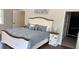 Main bedroom with decorative wood frame bed, wood floors, and lots of natural light at 7152 Sandy Ln, Wesley Chapel, FL 33544