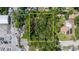 Aerial view showing a tree covered square parcel surrounded by commercial business and residences at 717 E 137Th Ave, Tampa, FL 33613
