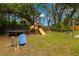 Beautiful backyard with a play area with a trampoline and wooden playhouse and slide for children at 717 E 137Th Ave, Tampa, FL 33613