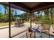 A view of a fenced-in backyard and patio area with outdoor furniture and a playset at 717 E 137Th Ave, Tampa, FL 33613
