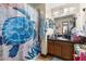 A bathroom with a single sink vanity with dark granite countertops and a unique shower curtain at 717 E 137Th Ave, Tampa, FL 33613