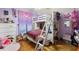 Bright ' bedroom with a bunk bed, play area, and a colorful decor with hardwood flooring at 717 E 137Th Ave, Tampa, FL 33613