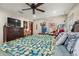 Bedroom features wood floors, a ceiling fan, and is furnished with a TV and wooden dresser at 717 E 137Th Ave, Tampa, FL 33613