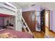 bedroom features a bunk bed, closet with folding doors, and hardwood floors at 717 E 137Th Ave, Tampa, FL 33613