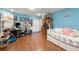 Spacious bonus room with sleeping and desk area featuring laminate flooring at 717 E 137Th Ave, Tampa, FL 33613