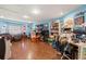 Spacious, blue bonus room offers versatile space with laminate flooring and a window at 717 E 137Th Ave, Tampa, FL 33613