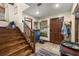 Inviting entryway with tile flooring, a wooden staircase, and natural light from the front window at 717 E 137Th Ave, Tampa, FL 33613