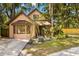 Charming two-story home featuring a manicured lawn, mature trees, and an inviting entrance at 717 E 137Th Ave, Tampa, FL 33613