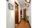 Hallway with wood flooring, skylights, a monstera plant, and access to various rooms including a bedroom visible through a door at 717 E 137Th Ave, Tampa, FL 33613