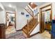 Traditional hallway with a wooden staircase, tile floors, and a view into the living room at 717 E 137Th Ave, Tampa, FL 33613