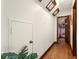 Hallway view featuring wood floors, a storage closet, skylights, and an open doorway to the bedroom at 717 E 137Th Ave, Tampa, FL 33613