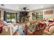 Cozy living room featuring a stone fireplace, hardwood floors, and sliding glass doors to the outside at 717 E 137Th Ave, Tampa, FL 33613