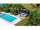 Inviting backyard features a sparkling pool and hammock area shaded by tropical palm trees at 7304 Lakeside Blvd, Tampa, FL 33614