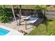 Backyard view with a cozy hammock area adjacent to the pool, offering a serene retreat at 7304 Lakeside Blvd, Tampa, FL 33614