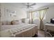 Cozy bedroom featuring a ceiling fan, neutral tones, and natural light at 7304 Lakeside Blvd, Tampa, FL 33614