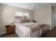 Cozy bedroom with neutral colors, wood floors, a ceiling fan, and a window with natural light at 7304 Lakeside Blvd, Tampa, FL 33614