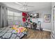 Bedroom featuring wood-look floors, a ceiling fan, and a desk area at 7304 Lakeside Blvd, Tampa, FL 33614