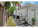 Home exterior featuring AC, water heater, and pool equipment along the side of the house and a gate at 7304 Lakeside Blvd, Tampa, FL 33614