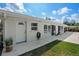 The backyard of the house is accessible via a door and sliding glass doors, complemented by a concrete patio at 7304 Lakeside Blvd, Tampa, FL 33614