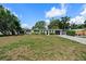 Charming single-story home with a manicured lawn, established landscaping, and an attached garage at 7304 Lakeside Blvd, Tampa, FL 33614