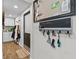 Functional hallway with key hooks and a whiteboard by the front door and a view to the kitchen at 7304 Lakeside Blvd, Tampa, FL 33614