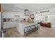 Bright kitchen offers an island with seating and stainless appliances; view into adjacent living area at 7304 Lakeside Blvd, Tampa, FL 33614
