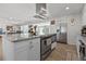 Well-equipped kitchen with stainless steel oven, range hood and a stainless steel refrigerator at 7304 Lakeside Blvd, Tampa, FL 33614