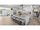 Bright kitchen features a large island, stainless hood vent, white cabinetry, and stainless steel appliances at 7304 Lakeside Blvd, Tampa, FL 33614