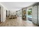 Spacious living room featuring wood-look floors and sliding doors to the pool area at 7304 Lakeside Blvd, Tampa, FL 33614