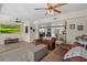Cozy living room with ceiling fans, warm wood-look floors, and comfortable leather furniture at 7304 Lakeside Blvd, Tampa, FL 33614