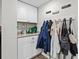 Functional mudroom with built-in cabinets, countertop, and hooks for storage and organization at 7304 Lakeside Blvd, Tampa, FL 33614