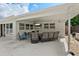 Relaxing covered patio features a TV, comfortable seating, and ample space for outdoor enjoyment at 7304 Lakeside Blvd, Tampa, FL 33614