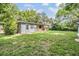 Large backyard with home, lawn and garden at 7347 Pulsar St, New Port Richey, FL 34652