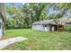 Exterior of home with a covered porch and a lush backyard at 7347 Pulsar St, New Port Richey, FL 34652