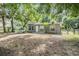 Quaint single-story home with a welcoming fenced front yard and mature trees at 7347 Pulsar St, New Port Richey, FL 34652
