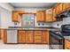 Kitchen featuring wood cabinets, stainless steel dishwasher, and plenty of counter space at 7347 Pulsar St, New Port Richey, FL 34652