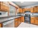 Charming kitchen featuring wood cabinets, ample counter space, and stainless dishwasher at 7347 Pulsar St, New Port Richey, FL 34652