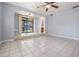 Tile floored living room featuring an open floor plan and access to a covered patio at 7347 Pulsar St, New Port Richey, FL 34652