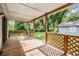 Covered porch with wood railing overlooking the yard at 7347 Pulsar St, New Port Richey, FL 34652