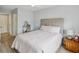 Bedroom with a plush bed, vanity, neutral walls, and wood floors at 7360 Ulmerton Rd # 18A, Largo, FL 33771