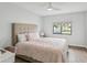 Bedroom with a plush bed, ceiling fan, neutral walls, and wood floors at 7360 Ulmerton Rd # 18A, Largo, FL 33771