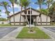 Community clubhouse with palm trees and well-maintained landscape at 7360 Ulmerton Rd # 18A, Largo, FL 33771
