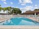 Community pool featuring lounge seating and nearby covered area at 7360 Ulmerton Rd # 18A, Largo, FL 33771
