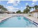 Community pool featuring poolside lounge chairs and ample space for relaxation at 7360 Ulmerton Rd # 18A, Largo, FL 33771