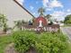 Rose Tree Village sign amid lush greenery and manicured landscaping at 7360 Ulmerton Rd # 18A, Largo, FL 33771